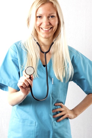 Pretty young female surgeon posing in uniformの写真素材