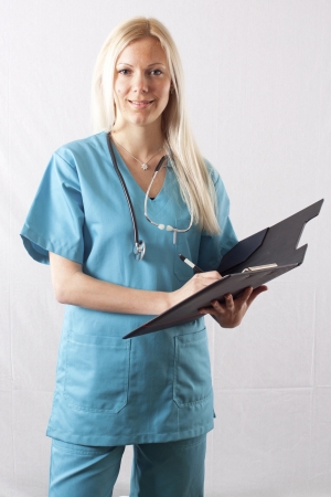 Pretty young female surgeon posing in uniformの写真素材