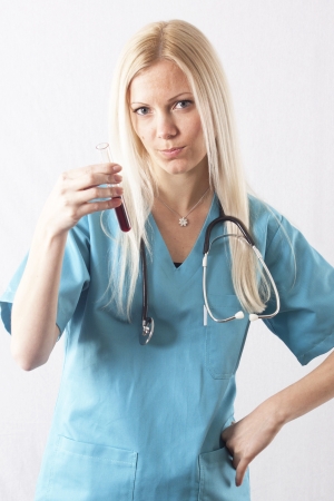 Pretty young female surgeon posing in uniformの写真素材