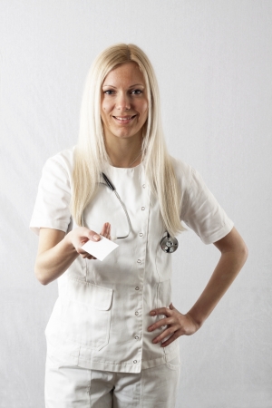 Pretty young female surgeon posing in uniformの写真素材