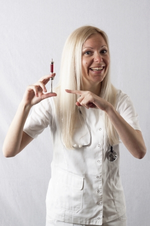 Pretty young female surgeon posing in uniformの写真素材