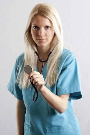 Pretty young female surgeon posing in uniformの写真素材