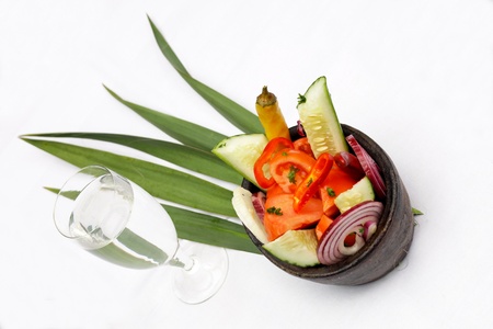 Tasty salad served in a dish with a glass of waterの写真素材