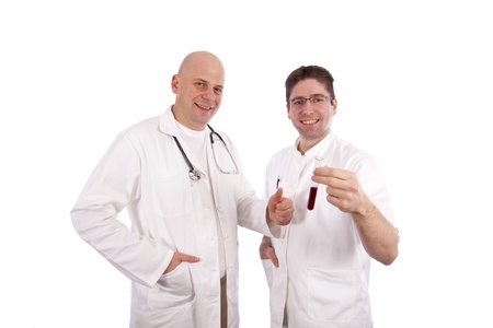 Two doctors smiling and holding a test tubeの写真素材