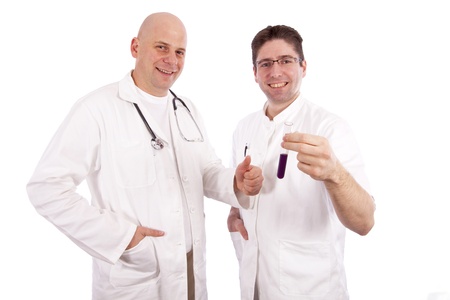Two doctors smiling and holding a test tubeの写真素材