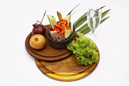 Tasty salad served in a dish with a glass of waterの写真素材