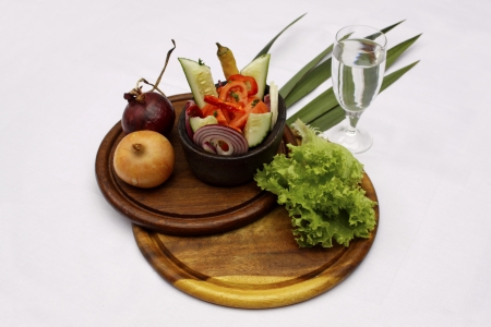 Tasty salad served in a dish with a glass of waterの写真素材