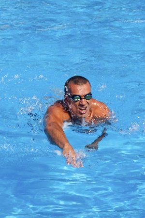 Athletic swimmer training in a swimming poolの写真素材