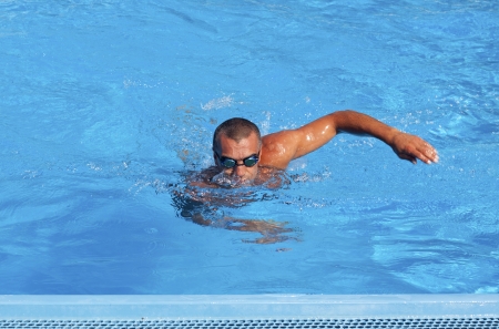 Athletic swimmer training in a swimming poolの写真素材