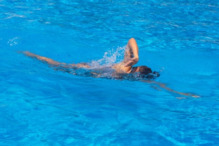 Pretty young female swimmer posing in swimming poolの写真素材