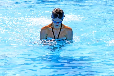 Active girl swimming in swimming pool