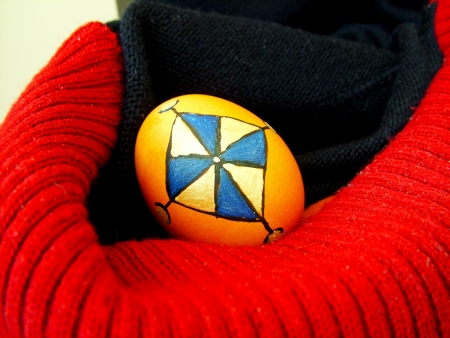 Beautiful painted easter egg on a colorful backgroundの写真素材