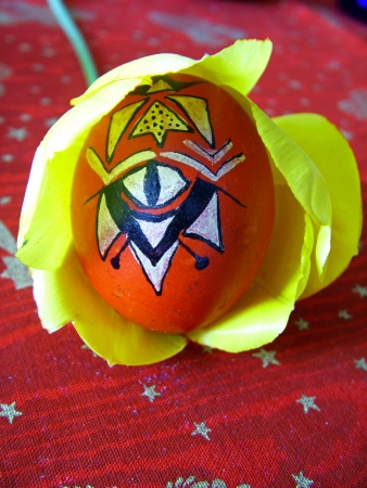 Beautiful painted easter egg on a colorful backgroundの写真素材