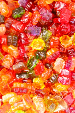 Many colorful Halloween sweets and candy filling backgroundの写真素材