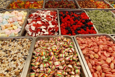 Many colorful Halloween sweets and candy filling backgroundの写真素材