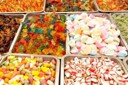 Many colorful Halloween sweets and candy filling backgroundの写真素材