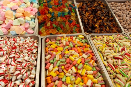 Many colorful Halloween sweets and candy filling backgroundの写真素材