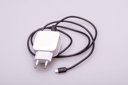 White mobile phone chargers on white background