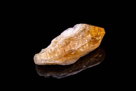 Citrine gemstone isolated on black background. Macro shot.