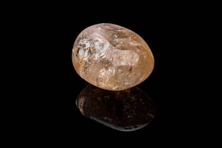 Citrine gemstone isolated on black background. Macro shot.の写真素材