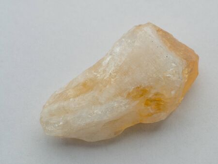 Citrine gemstone isolated on white background. Macro shot.