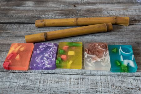 Spa concept. aromatic soaps and bamboo sticks on wooden background