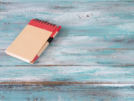 Notepad on wooden background.Concept photoの写真素材