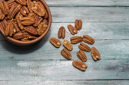Pecan nuts on wooden background. Healthy food