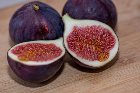 Macro shot of organic figs on wooden background. Selective focus