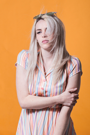 Young woman posing against yellow backgroundの写真素材