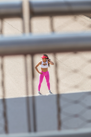 Female athletic runner in park in the summer, resting after a jog, fitness and healthy lifestyle conceptの写真素材
