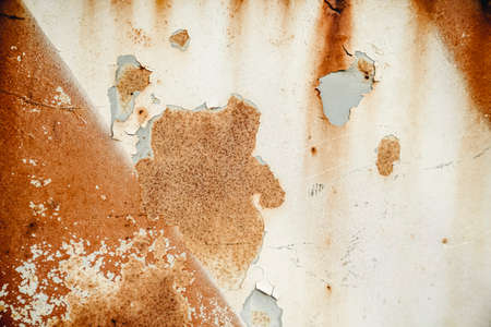 Brown, black and yellow rust and dirt on white enamel. Rusted brown and white abstract texture. Corroded white metal background. Rusty metal surface with streaks of rust. Rusty corrosion.Rusted metalの写真素材