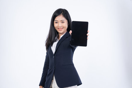 Portrait of corporate woman reads news, works on her digital tablet while on her way to office, Business woman portrait, holding a tablet in his handの写真素材