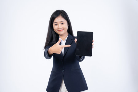 Portrait of corporate woman reads news, works on her digital tablet while on her way to office, Business woman portrait, holding a tablet in his handの写真素材