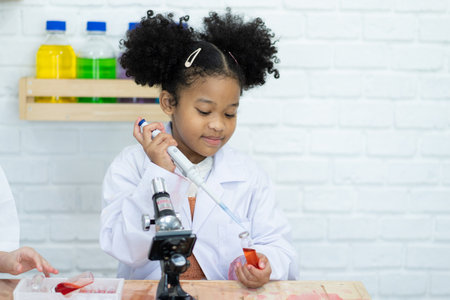 Class back to school. Educational concept happy children. scientist enjoy and excite to examine the color. School chemistry laboratory. Enjoying student life.の写真素材