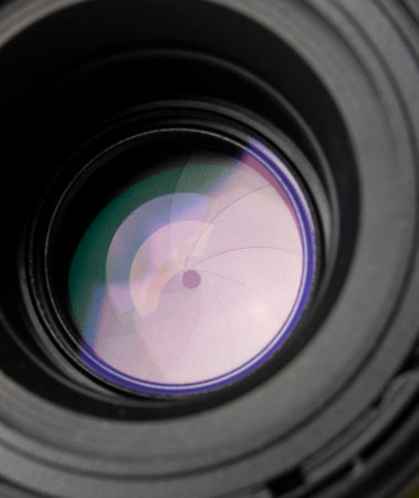 Close up of a camera lens with a blue and purple reflection.の写真素材