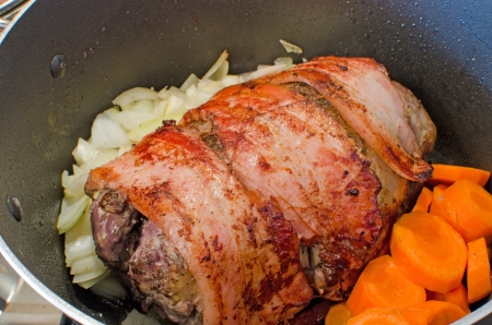 Cooking wild pheasant with bacon and vegetablesの写真素材