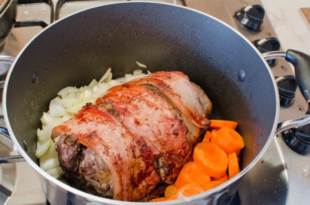 Cooking wild pheasant with bacon and vegetablesの写真素材