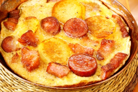 Omelet with potatoes, bacon and sausage             の写真素材