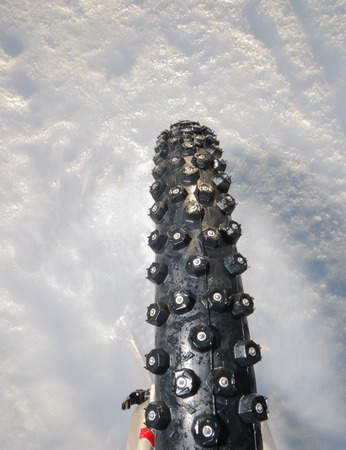 Mountain bike winter tire with spikes prevents slipping and slidingの写真素材