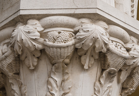 Column capital at Doge's Palace in Venice shows architectural details of baskets filled with fruitの写真素材