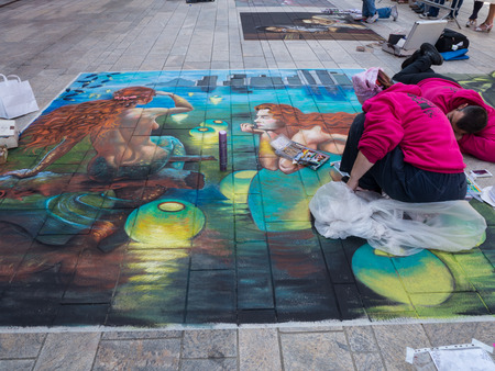 ALMERE, NETHERLANDS - JUNE 30: Artist at work on a street painting during the annual Steet Art Festival held in the streets of the city of Almere on June 30, 2013のeditorial素材