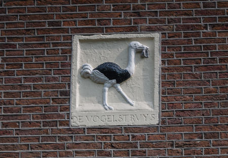 AMSTERDAM, NETHERLANDS - 6 SEPT. 2013: Decoration on Amsterdam canal house depicting an ostrich of which the meaning is unknown. Many of the canal houses were built for the aristocracy more than 400 years ago and are now in use as houses, offices and shopのeditorial素材