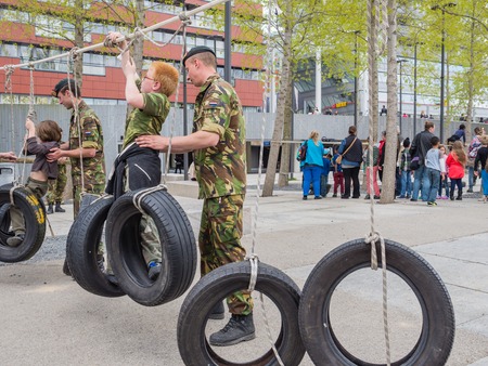 ALMERE, NETHERLANDS - 23 APRIL 2014: Children battling part of a military assault course on National...