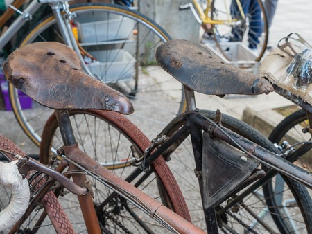 GAIOLE IN CHIANTI, ITALY - 4 OCT. 2014: The old leather saddles of vintage bicycles on display at L\'Eroica, a touristic and historic cycling event for owners of vintage bicycles who ride a tour through the province of Tuscany, mainly on gravel roads.のeditorial素材