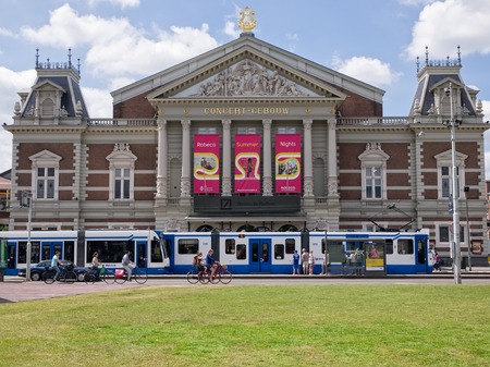 AMSTERDAM - 2 JULY 2014: A tram passes the Royal Concertgebouw at Museumplein in Amsterdam. The neoclassical concert hall is world famous for its great acoustics and is considered one of the finestのeditorial素材