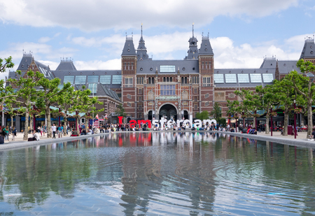 AMSTERDAM - 2 JULY 2014:Tourists sit around the I Love Amsterdam sign at national Rijksmuseum, a popular tourist destination. It attracts more than 2 million visitors each year from all over the worldのeditorial素材
