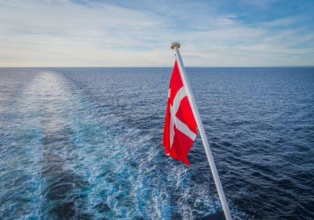 Danish flag hanging from the stern of a ferry a ship crossing the north seaの写真素材