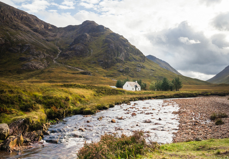 Climbers cottage at Lagangarbh close to Buachaille Etive Mor and Buachaille Etive Beag as seen from the River Coupall in the Glen Coe area, Scotlandの写真素材