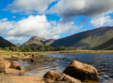 Wide view of Loch Etive in the Glencoe Valley surrounded by the Grampian Mountains, Scotlandの写真素材